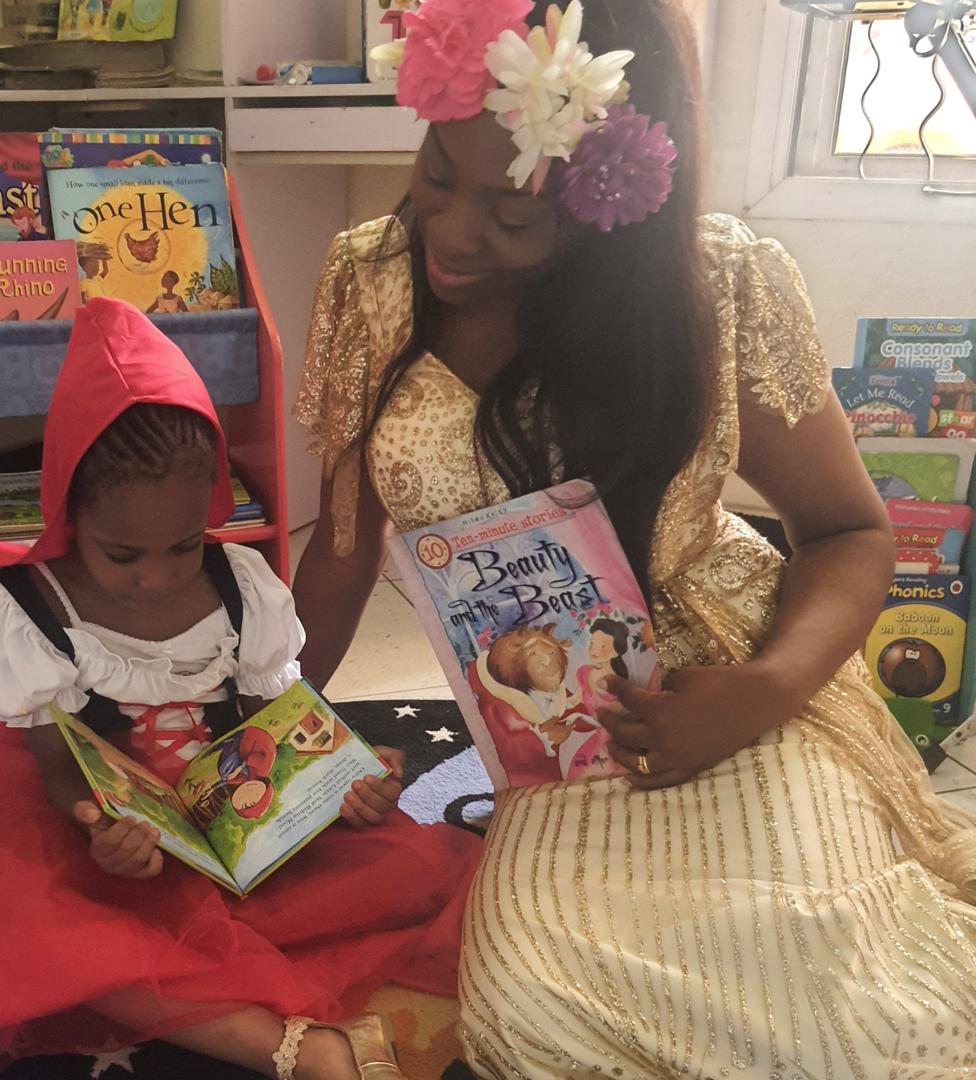 Children laughing together in a book club reading circle
